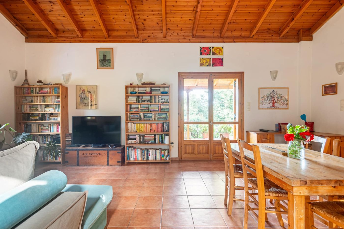 The dining area, open to the living room and lined with bookshelves.