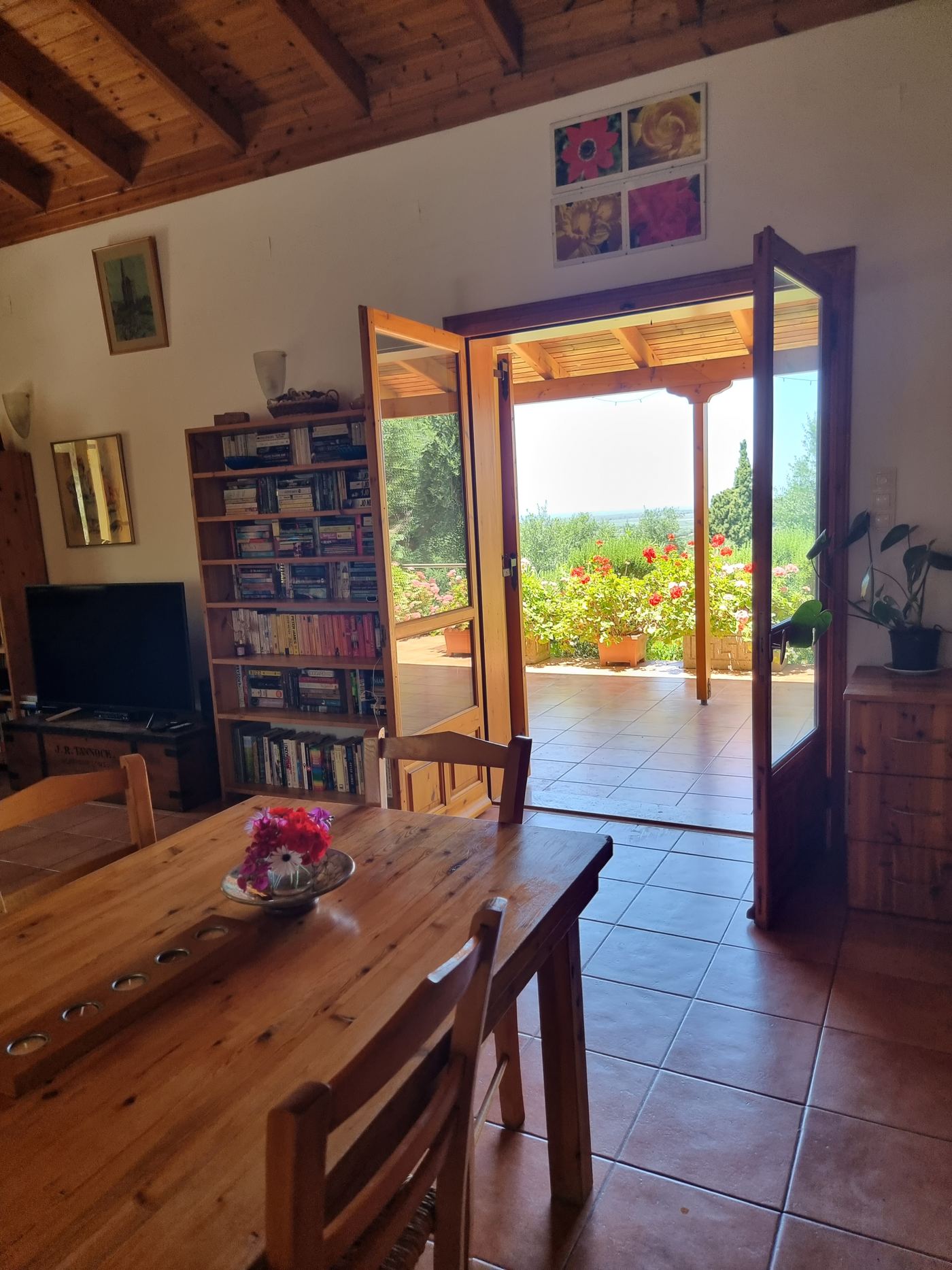 The dining table, looking out through the open doors to the sea.