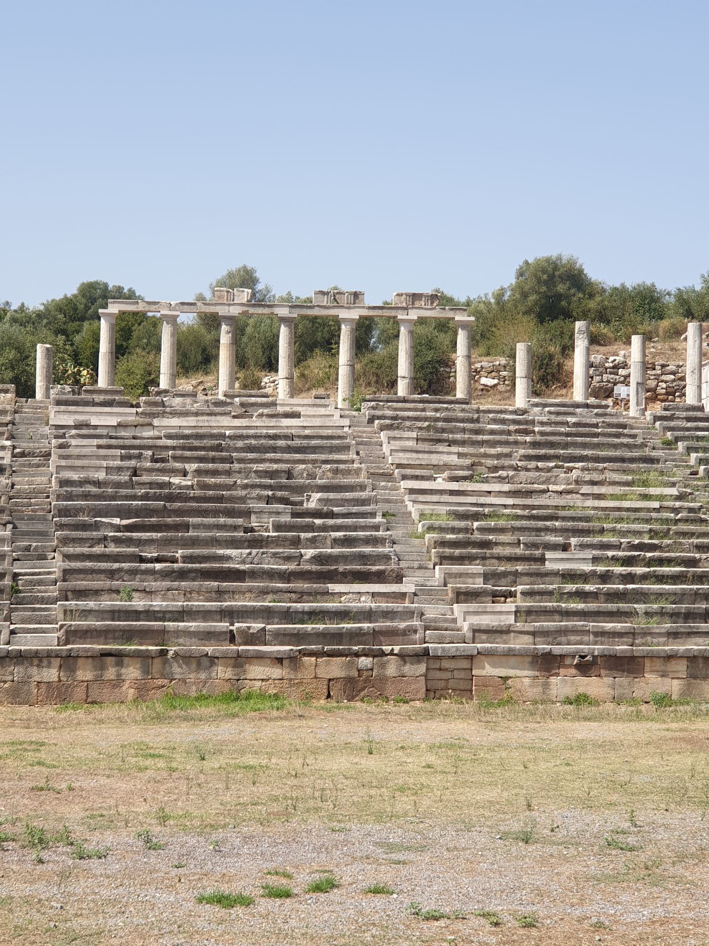 The stadium, with its seats in long straight rows.